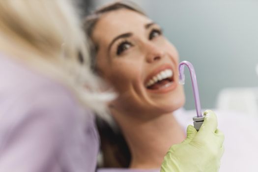 Close-up of a young woman having a consultation with her dentist.