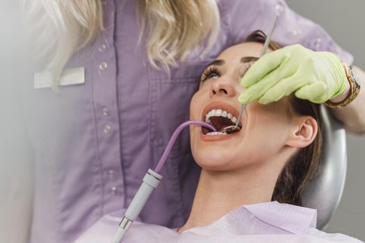 Close-up of a young woman having dental work done on her teeth.