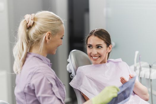 Shot of a young woman having a consultation with her dentist.