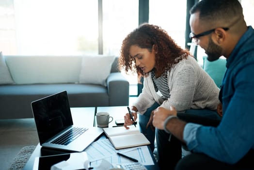 Getting about their household admin. a young couple planning their budget together at home