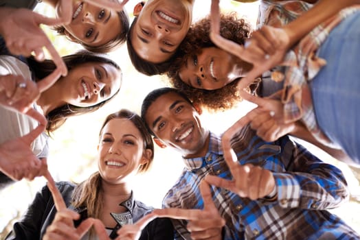 Portrait, finger star and friends in circle with diversity, unity and collaboration with low angle. Happy, smile and group of people in huddle together with hand gesture for solidarity and community