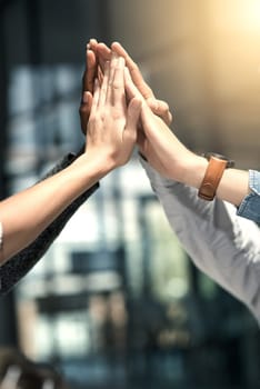 Put your hands together for success. a group of businesspeople joining their hands in solidarity