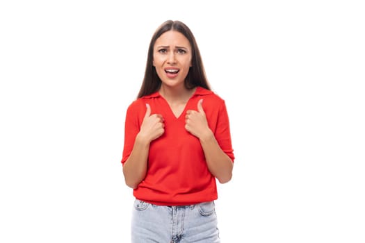 young excited brunette lady dressed in a red t-shirt on a white background.