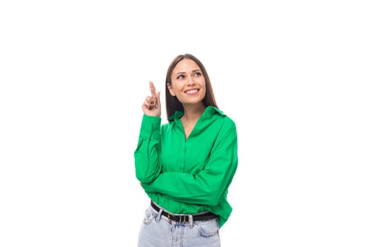 smart well-groomed brunette long-haired young woman in a green shirt on a white background with copy space.