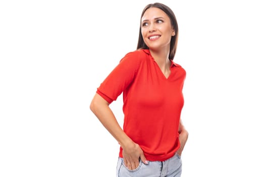 portrait of smiling pretty brunette woman with straight hair in red t-shirt and jeans isolated studio background with copy space.