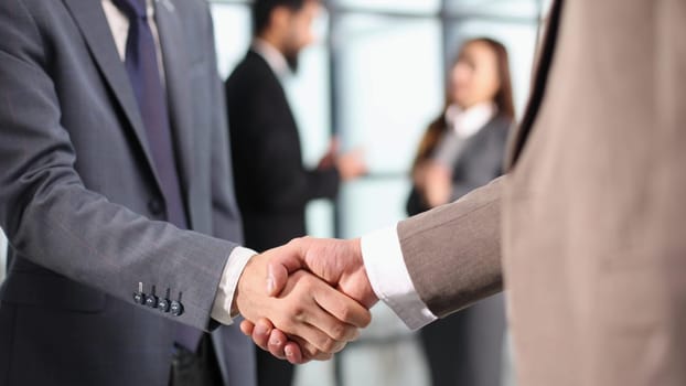 Close-up of business partners handshaking after successful agreement