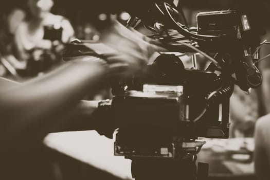 cinema video camera on tripod in film studio. Filmmaking equipment