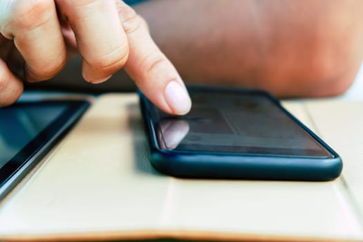 Closeup Image of Teenage guy text messaging on his phone