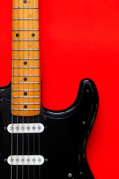 Electric Guitar on a red background.