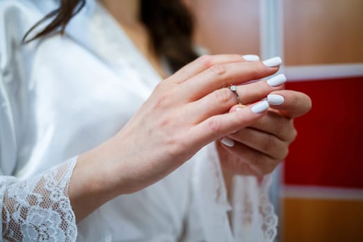 gold wedding rings in hands of newlyweds on wedding day