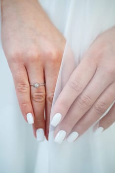 gold wedding rings in the hands of the newlyweds