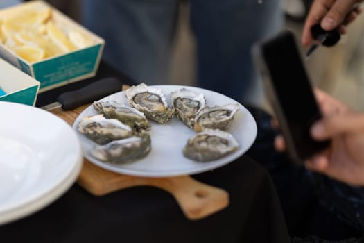 Oysters served on a plate at the restaurant. Mid shot