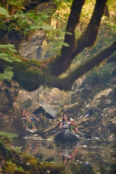 A group of friends enjoying having fun and kayaking while exploring the calm river, surrounding forest and large natural river canyons.