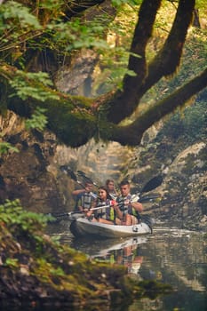 A group of friends enjoying having fun and kayaking while exploring the calm river, surrounding forest and large natural river canyons.