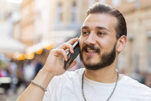 Portrait of man tourist having remote conversation communicate speaking by smartphone with friend, talking on phone unexpected good news gossip walking in urban city street. Town lifestyles outdoors