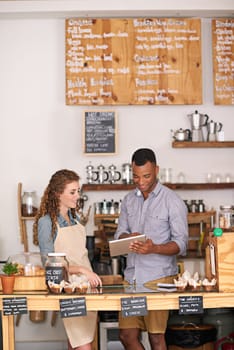 Coffee shop owners, tablet and teamwork of people, manage orders and discussion in store. Waiters, black man and happy woman in cafe with technology for inventory, stock check and managing sales