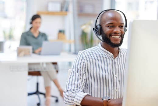 Call center, computer and happy man, virtual consultant or advisor in customer support, online advice and office. contact, communication and business agent or african person on desktop in workspace.