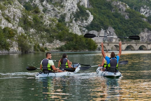 A group of friends enjoying having fun and kayaking while exploring the calm river, surrounding forest and large natural river canyons.