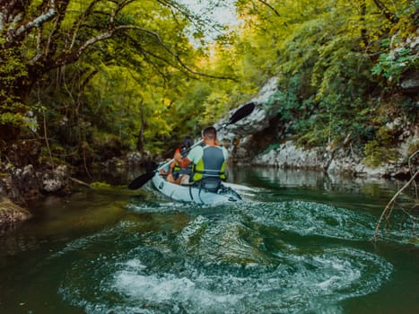 A young couple enjoying an idyllic kayak ride in the middle of a beautiful river surrounded by forest greenery.