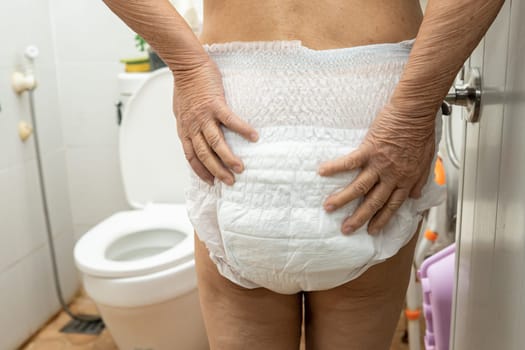 Asian senior woman patient wearing incontinence diaper in hospital, healthy strong medical concept.