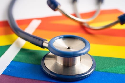 Stethoscope on rainbow flag background, symbol of LGBT pride month celebrate annual in June social, symbol of gay, lesbian, bisexual, transgender, human rights and peace.