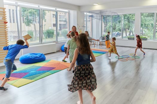 A child hugging a teacher in a modern kindergarten. High quality photo