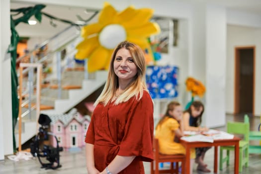 Portrait of a teacher in a preschool institution, in the background of the classrooms. High quality photo