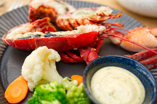 Cooked fresh lobster. Red lobster dinner seafood. Gourmet food healthy boiled lobster on plate. Grill of the Japanese high quality lobster.