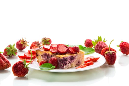 cooked cottage cheese casserole with berry and strawberry filling in a plate, isolated on white background.
