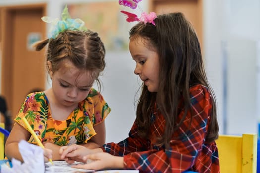 Creative kids sitting in a preschool institution, draw and have fun while they get an education. High quality photo