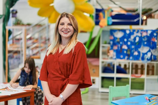 Portrait of a teacher in a preschool institution, in the background of the classrooms. High quality photo