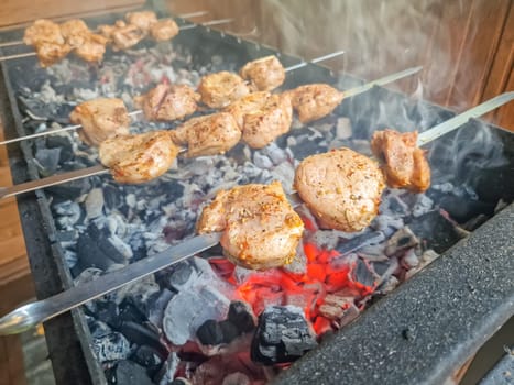 Assorted delicious grilled meat with vegetables over the coals on barbecue