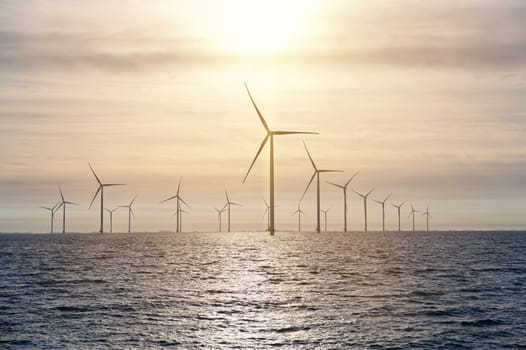 Offshore Windmill farm. windmills isolated at sea on a beautiful bright day Netherlands. green energy Flevoland global warming renewable enrgy with windmills