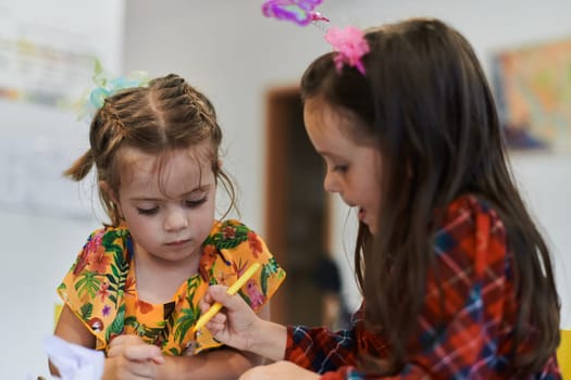 Creative kids sitting in a preschool institution, draw and have fun while they get an education. High quality photo