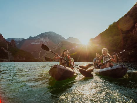 A group of friends enjoying fun and kayaking exploring the calm river, surrounding forest and large natural river canyons during an idyllic sunset