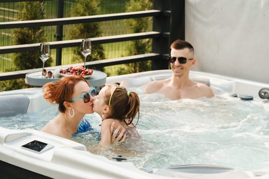 In summer, the family rests in the outdoor hot tub.