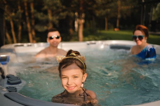 In summer, the family rests in the outdoor hot tub.