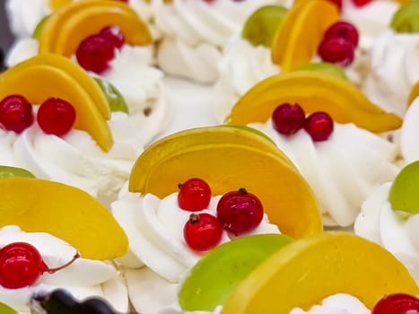 Mini cakes with berries and fruits close up. raspberry, blueberry and kiwi. delicious small tarts