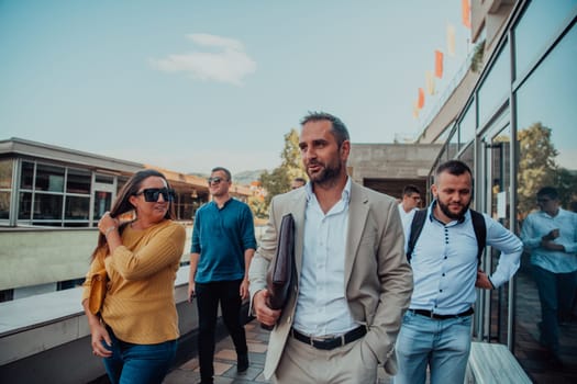 A diverse group of businessmen and colleagues walking together by their workplace, showcasing collaboration and teamwork in the company