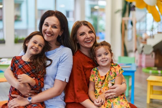 A child hugging a teacher in a modern kindergarten. High quality photo