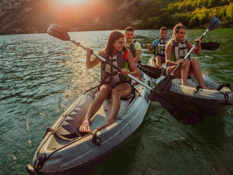 A group of friends enjoying fun and kayaking exploring the calm river, surrounding forest and large natural river canyons during an idyllic sunset