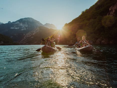 A group of friends enjoying fun and kayaking exploring the calm river, surrounding forest and large natural river canyons during an idyllic sunset