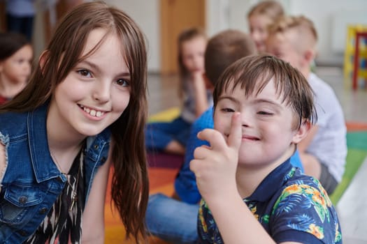 A girl and a boy with Down's syndrome in each other's arms spend time together in a preschool institution.