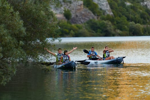 A group of friends enjoying having fun and kayaking while exploring the calm river, surrounding forest and large natural river canyons.