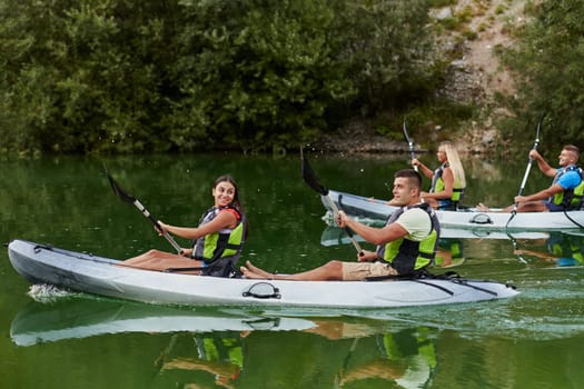 A group of friends enjoying having fun and kayaking while exploring the calm river, surrounding forest and large natural river canyons.