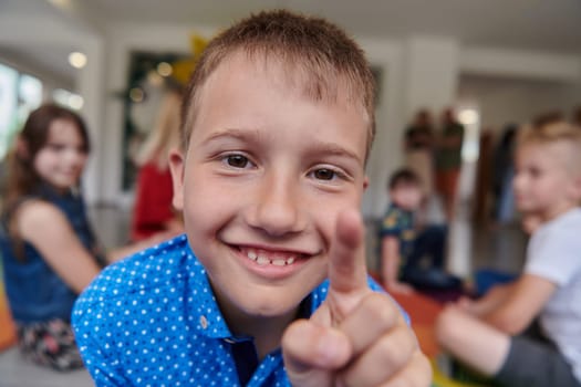 Portrait photo of a smiling boy in a preschool institution having fun. High quality photo