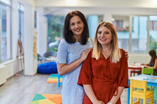 Portrait of a two teacher in a preschool institution, in the background of the classrooms.