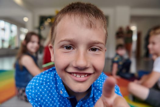 Portrait photo of a smiling boy in a preschool institution having fun. High quality photo