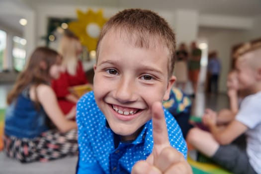 Portrait photo of a smiling boy in a preschool institution having fun. High quality photo