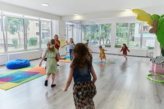 A child hugging a teacher in a modern kindergarten. High quality photo